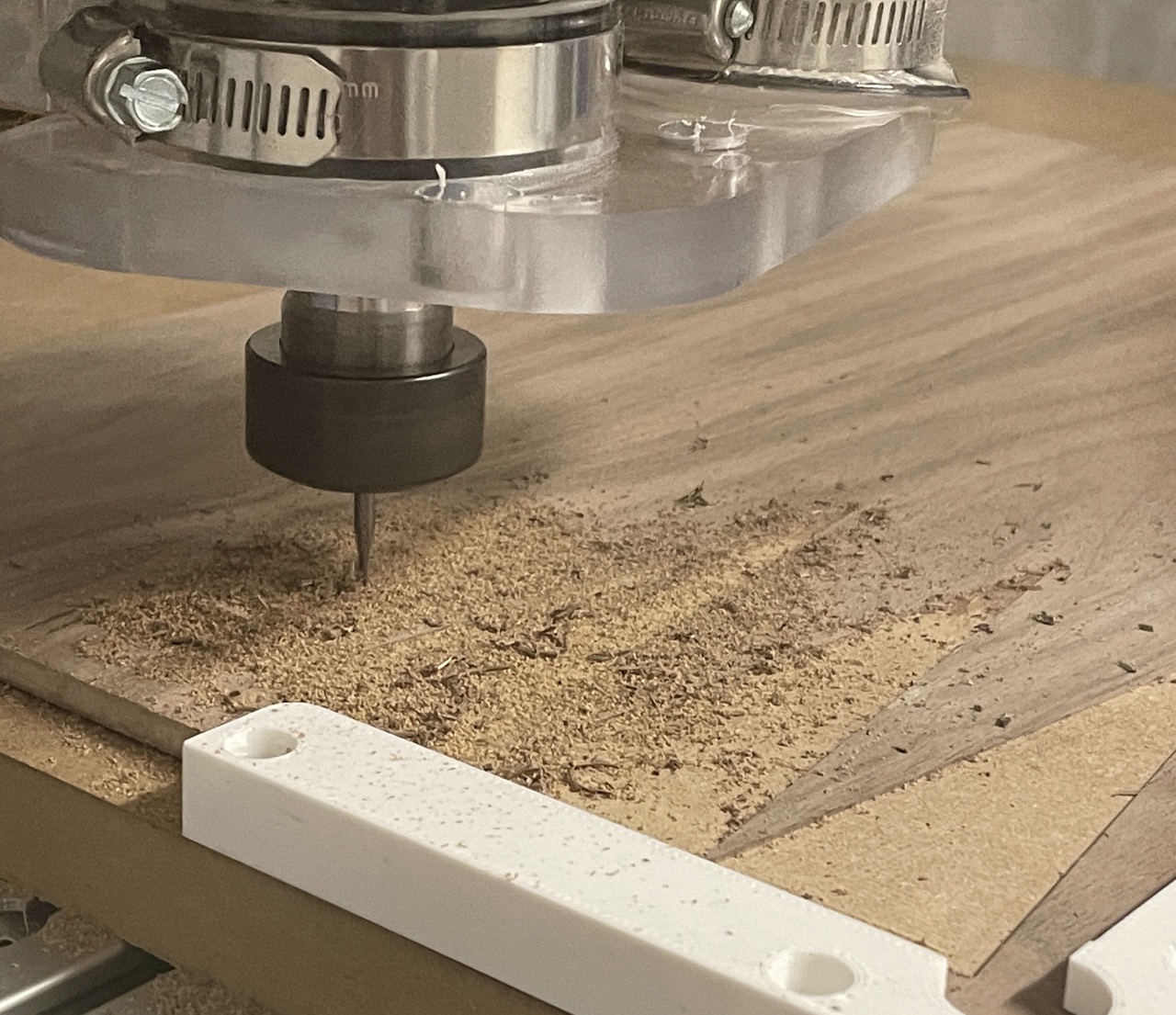 A CNC router cutting triangles into a piece of MDF